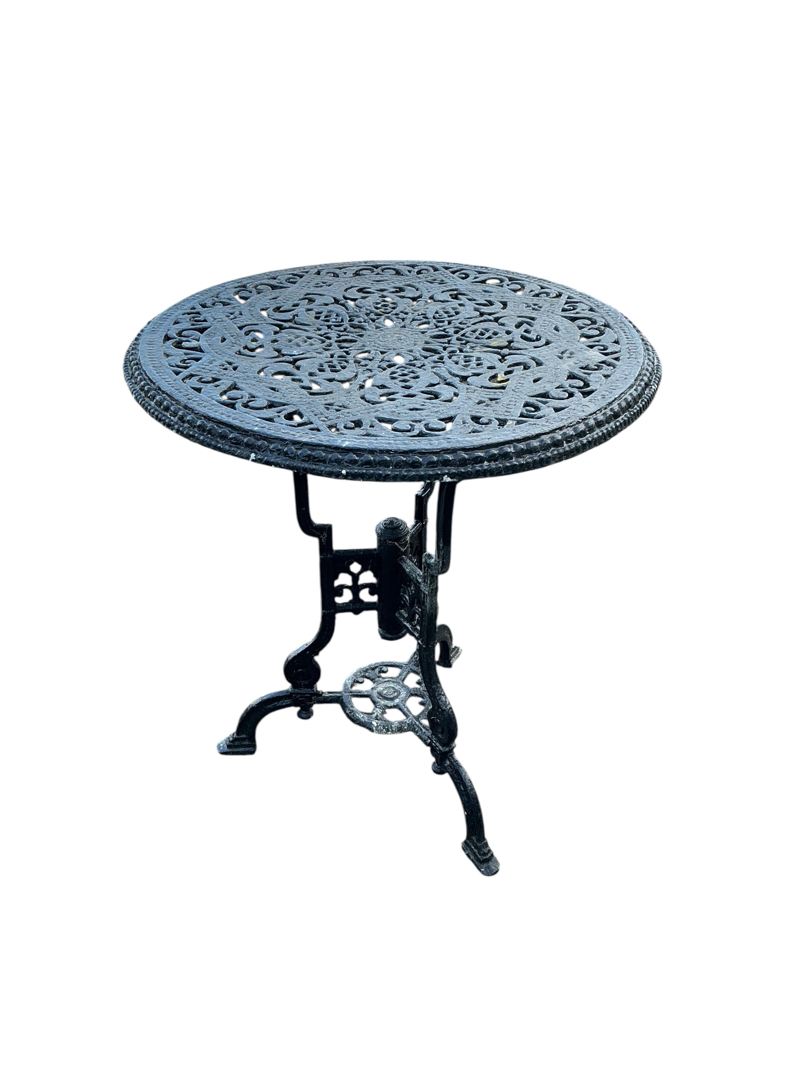 A Victorian style circular aluminium garden table, diameter 60cm together with two pairs of chairs